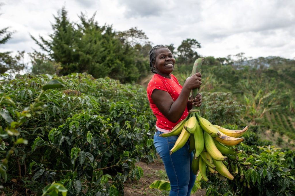 -Rocio-Mosquera-holds-bananas-in-La-Coqueta-farm-in-La-Sierra-Cauca-deparment-Colombia